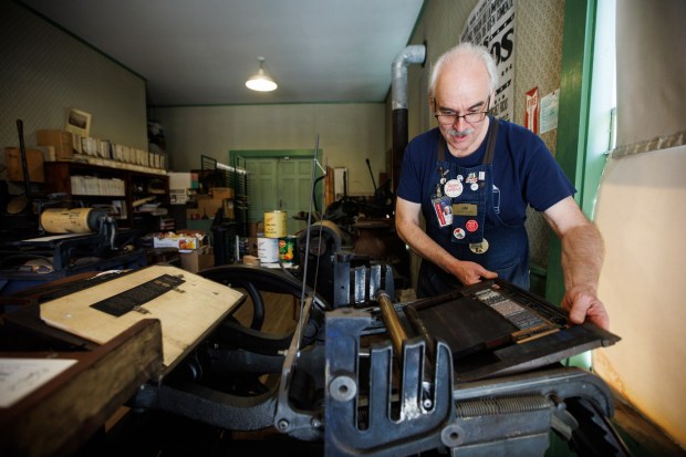 Jim Gard, chair of the San Jose Printers' Guild, demonstrates how he used a F. M. Weiler's Liberty printing press to make bookmarks commemorating the 50th anniversary of the print shop at History Park, on April 27, 2023, at History Park in San Jose, Calif. The San Jose Printers' Guild is holding its annual Printers' Fair and Wayzgoose, on April 29, the exact 50th anniversary of the opening of the print shop at History Park.(Dai Sugano/Bay Area News Group)