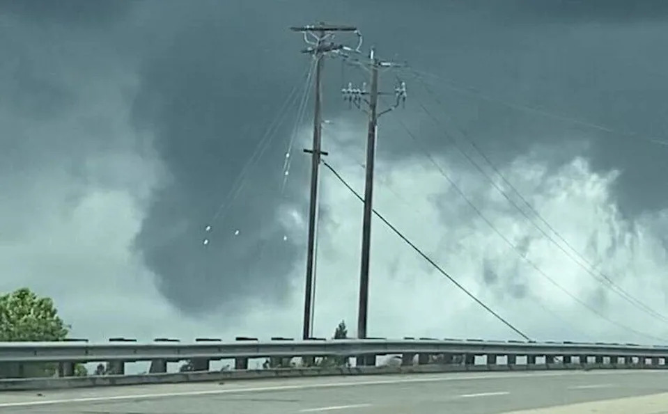 A small tornado funnel, confirmed by the National Weather Service, forms near Highway 99 and Herndon Avenue on Tuesday afternoon, though it didn’t touch down.