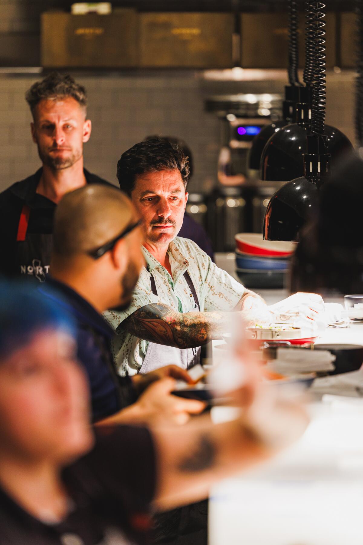 Chef Chris Curtiss runs the pass at North Italia Brea during a soft opening.