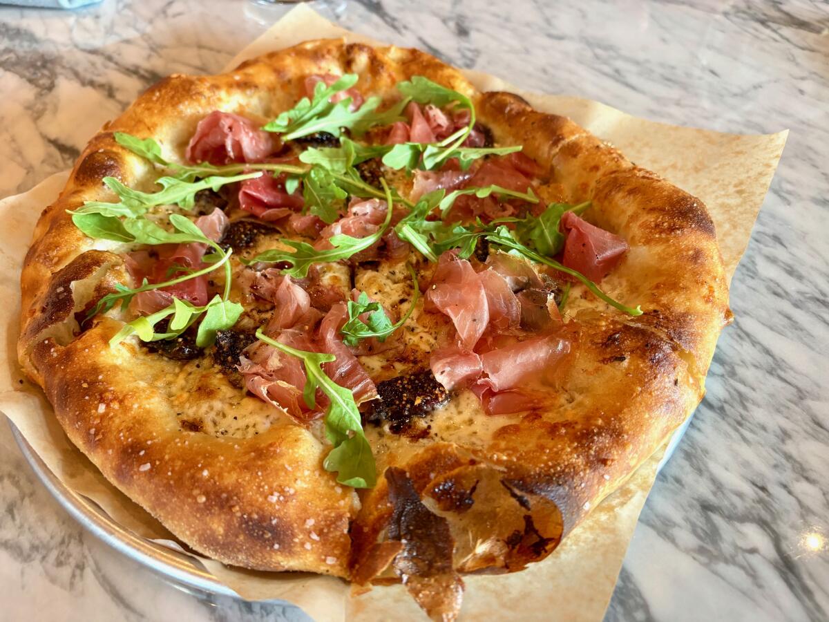 A fig and prosciutto pizza pairs sweet, jammy figs with Prosciutto di Parma.