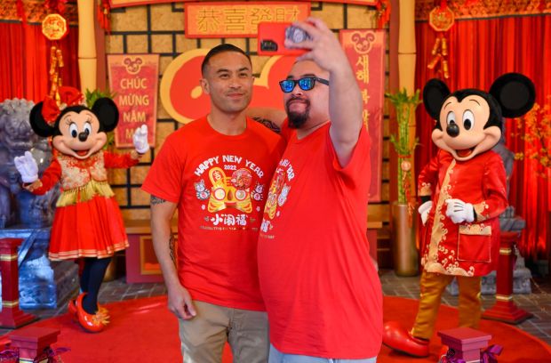 Brothers Jeff Morris, left, and Ben Morris, take a selfie with Mickey and Minnie during Lunar New Year in California Adventure at the Disneyland Resort in Anaheim, CA, on Friday, January 21, 2022. (Photo by Jeff Gritchen, Orange County Register/SCNG)