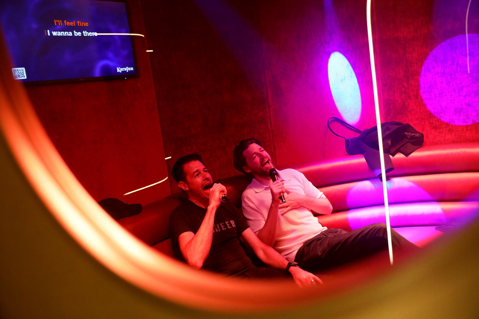 Brett Adams, left, of Sherman Oaks, and Patrick Riley of Studio City  sing together in one of the private rooms at Mic Drop.