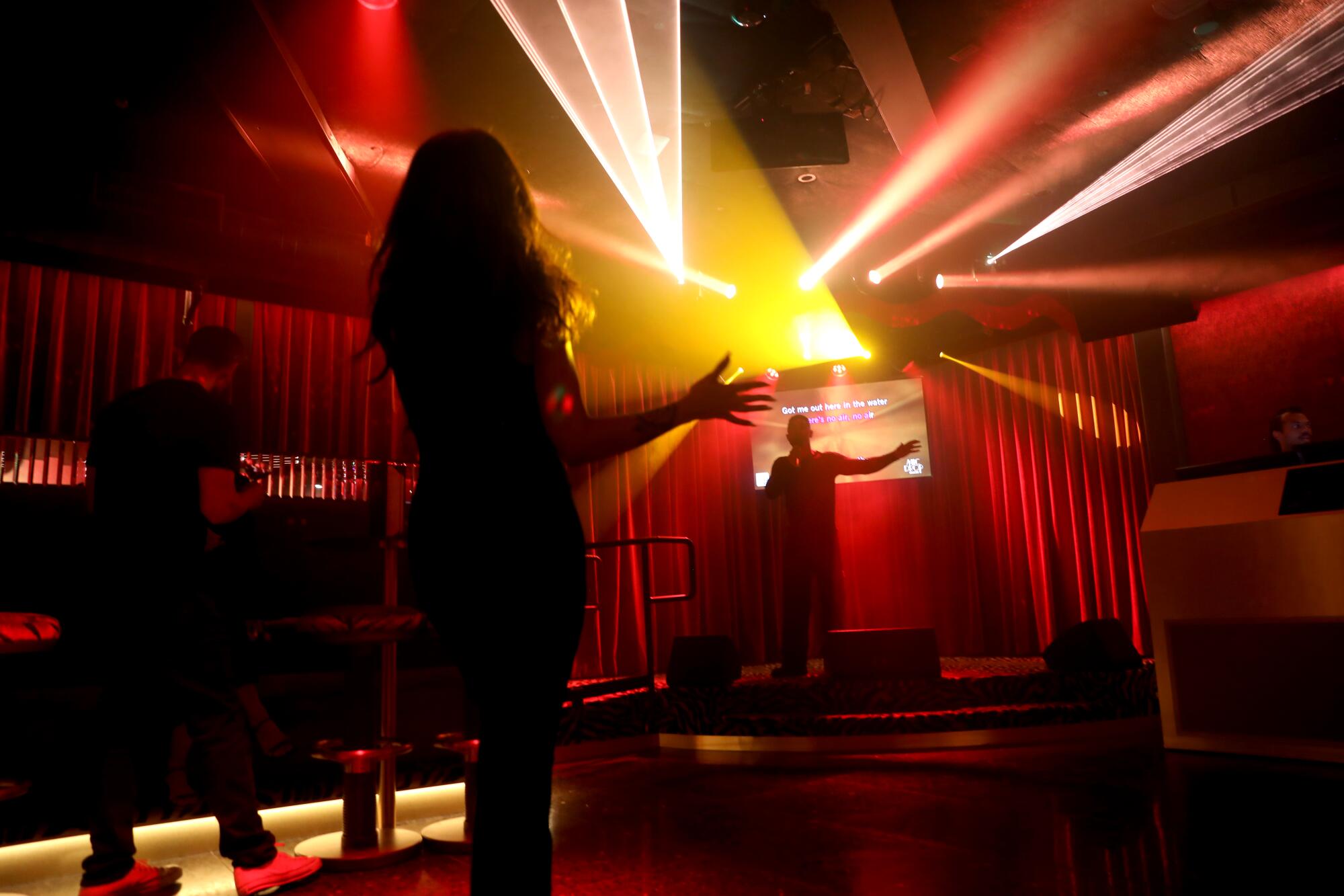 Lights beam on a stage.