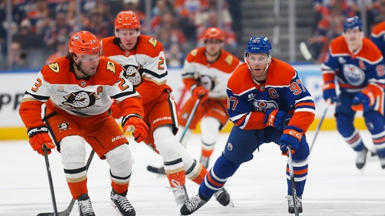 Anaheim Ducks' Mason McTavish (23) defends against Edmonton Oilers' Connor...