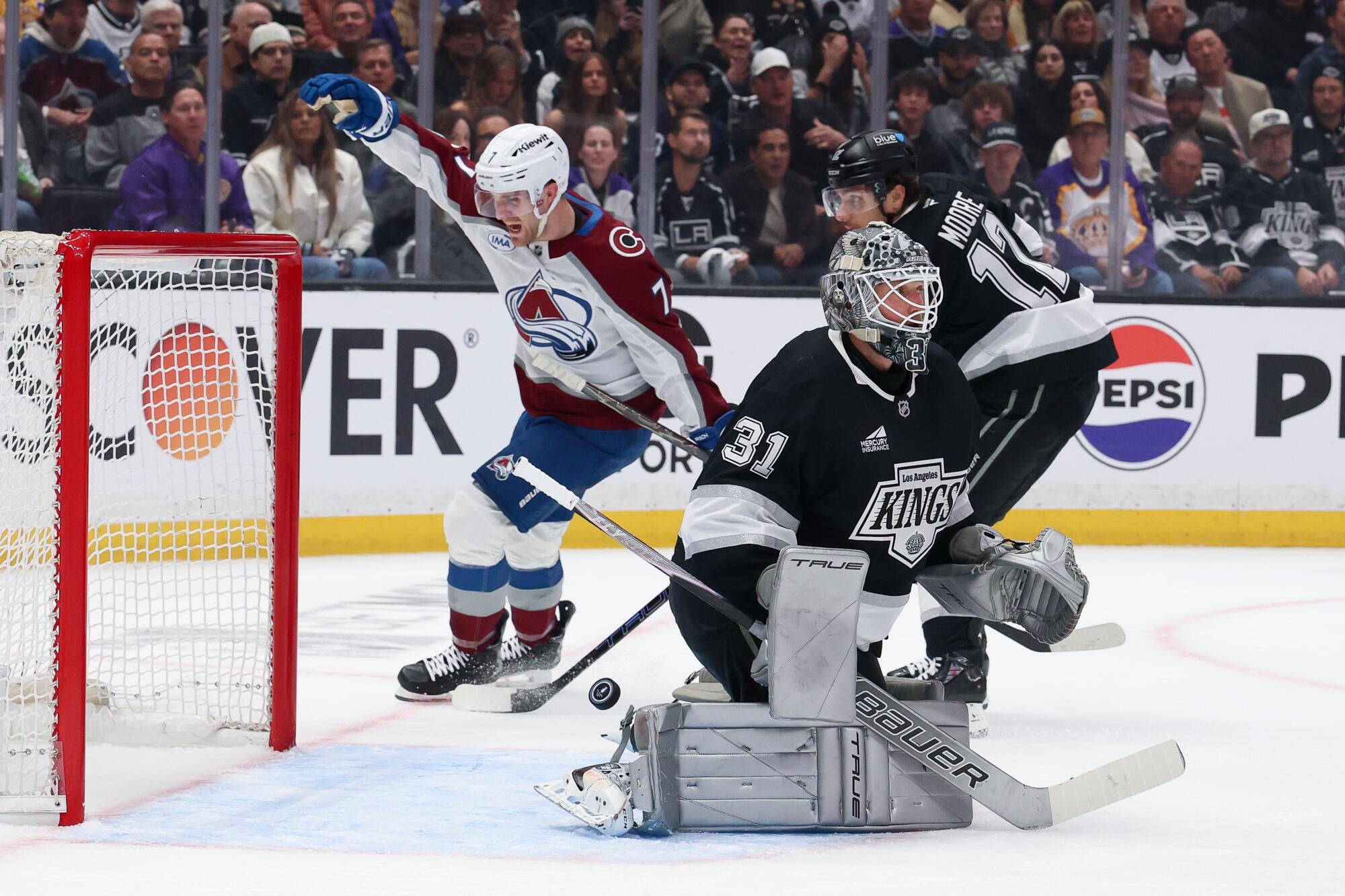Colorado Avalanche defenseman Devon Toews celebrates a goal by defenseman Cale Makar.