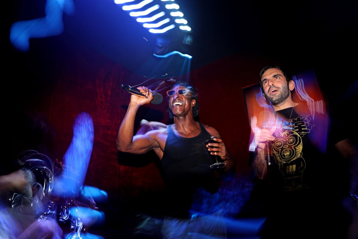 Two people sing in a private karaoke room at the new karaoke bar Mic Drop in West Hollywood