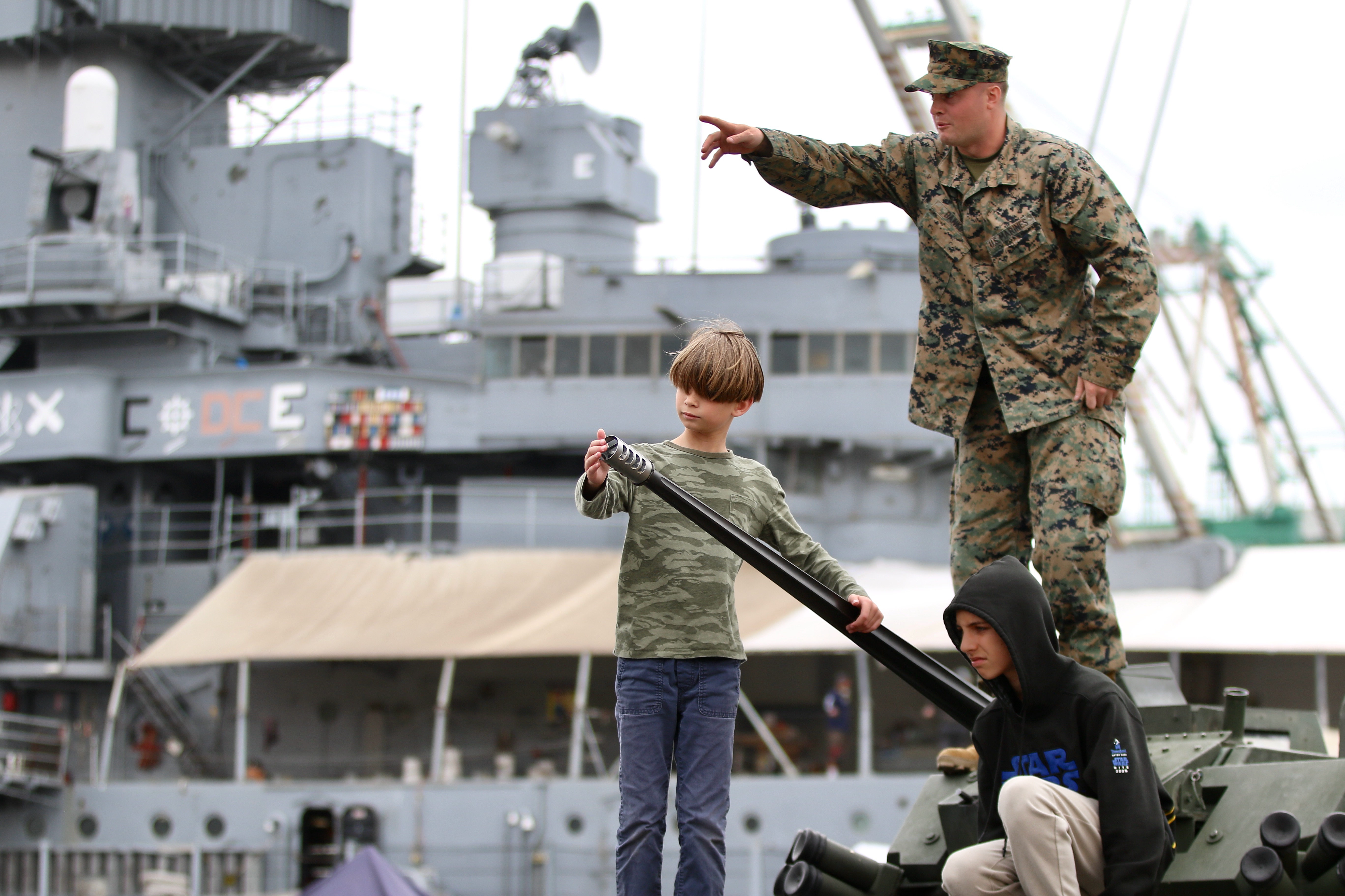 Young visitors learn about equipment as they interact with military...