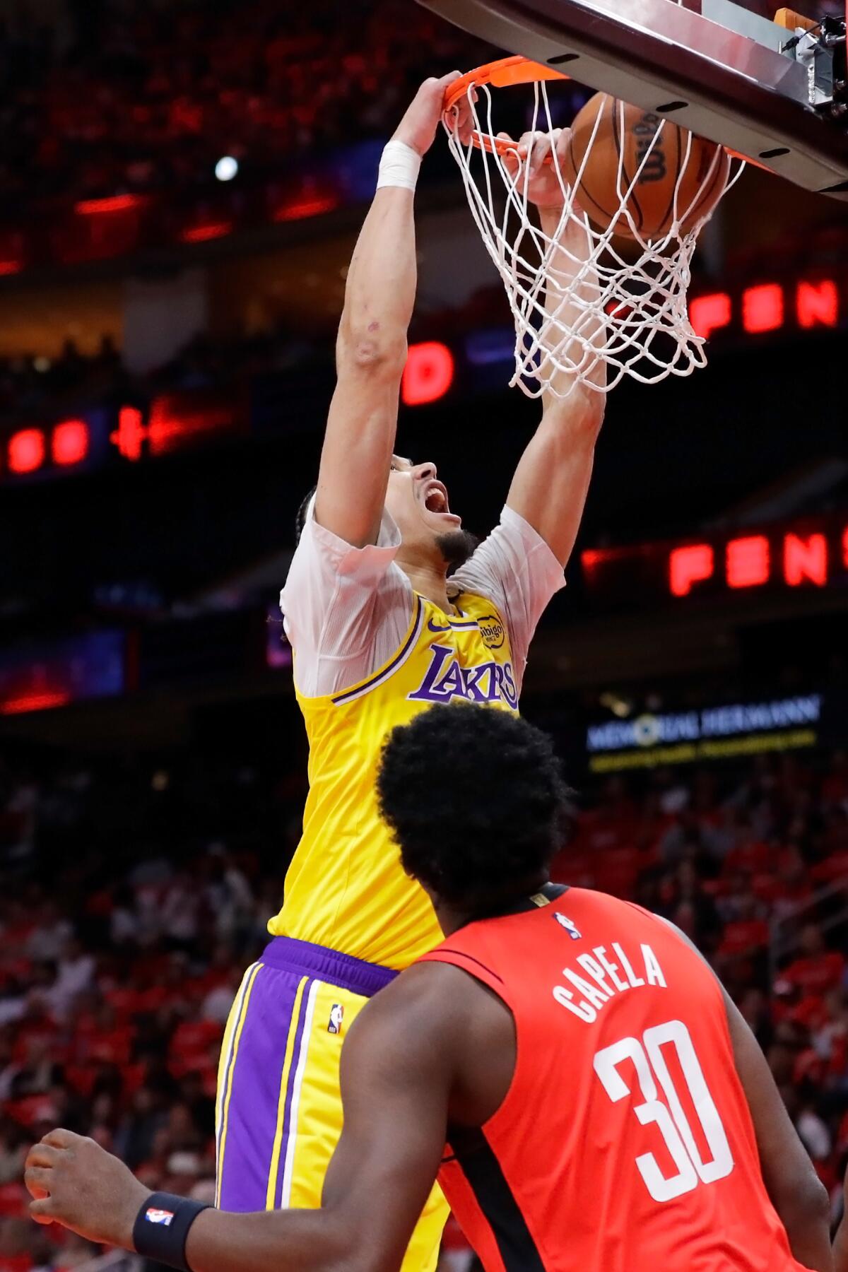 center Jaxson Hayes, left, dunks the ball over Rockets center Clint Capela, right, during the first half in Game 3.