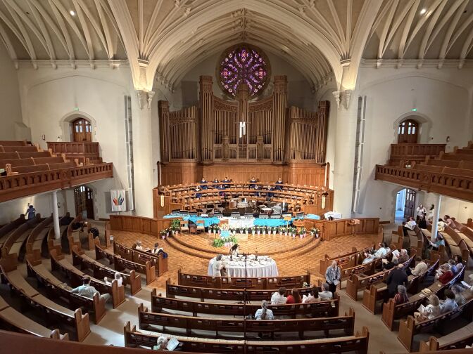 A large sanctuary with beautiful, ornate ceilings and an altar. 