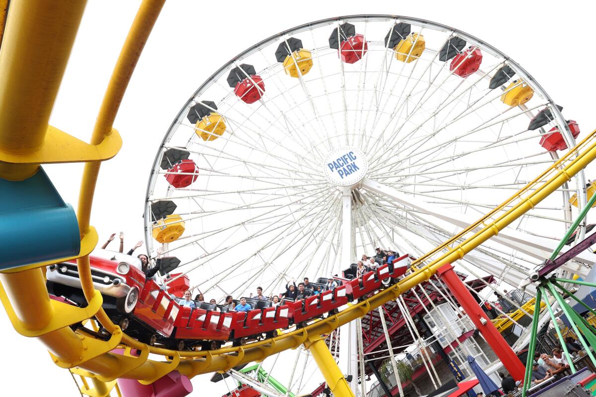 People ride the West Coaster at the Santa Monica Pier.