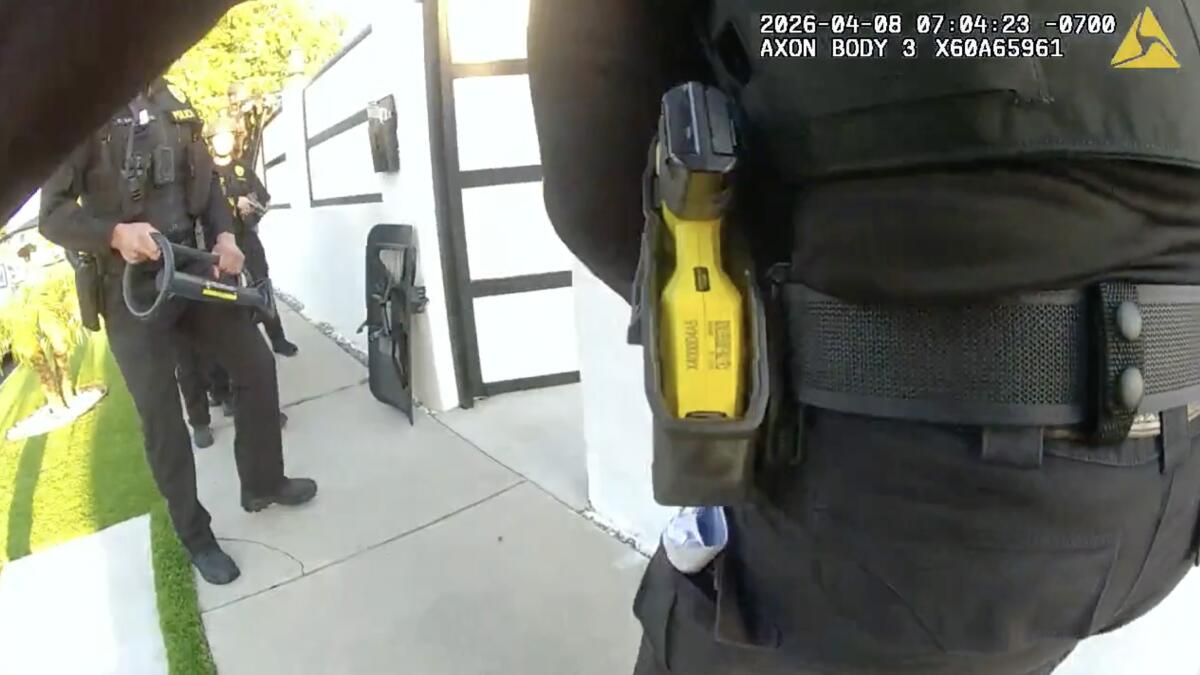 Law enforcement officers raid a home 