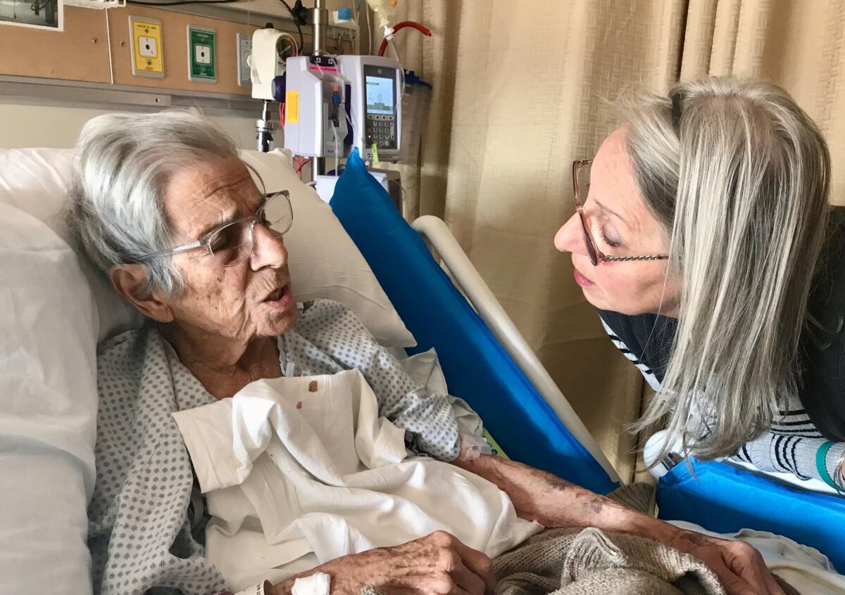 Grace Lopez, left, with daughter Debbie, before she was discharged from a hospital to hospice in January 2019. 