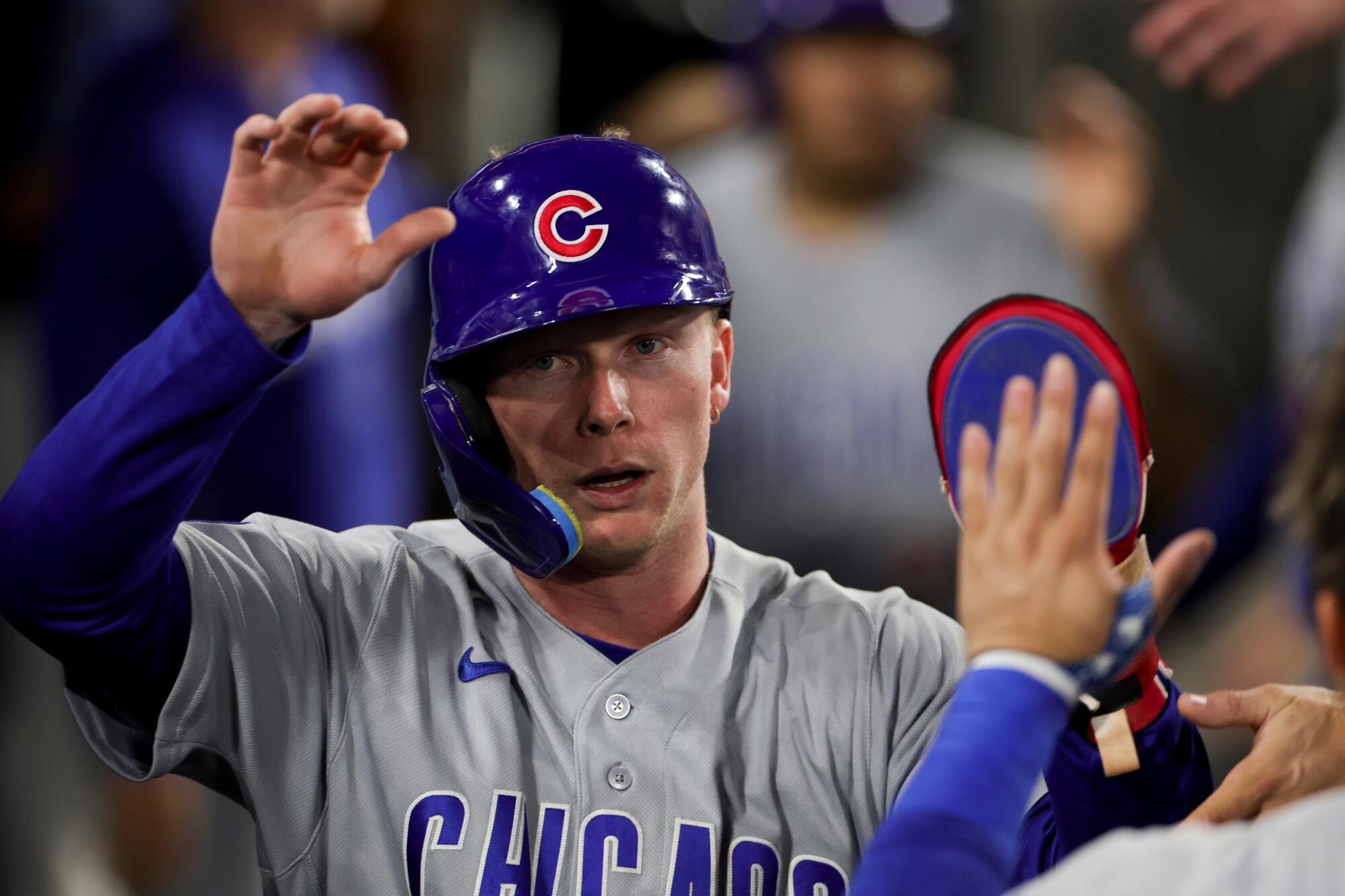 Pete Crow-Armstrong celebrates in the dugout after scoring off a triple hit by Dansby Swanson.