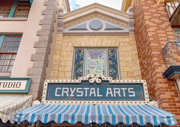 The Crystal Ball Glass Company window above the Crystal Arts gift shop on Disneyland's Main Street U.S.A. honoring Disney Legends Kim Irvine and Leota Toombs. (Courtesy of the official Walt Disney Imagineering Instagram account)