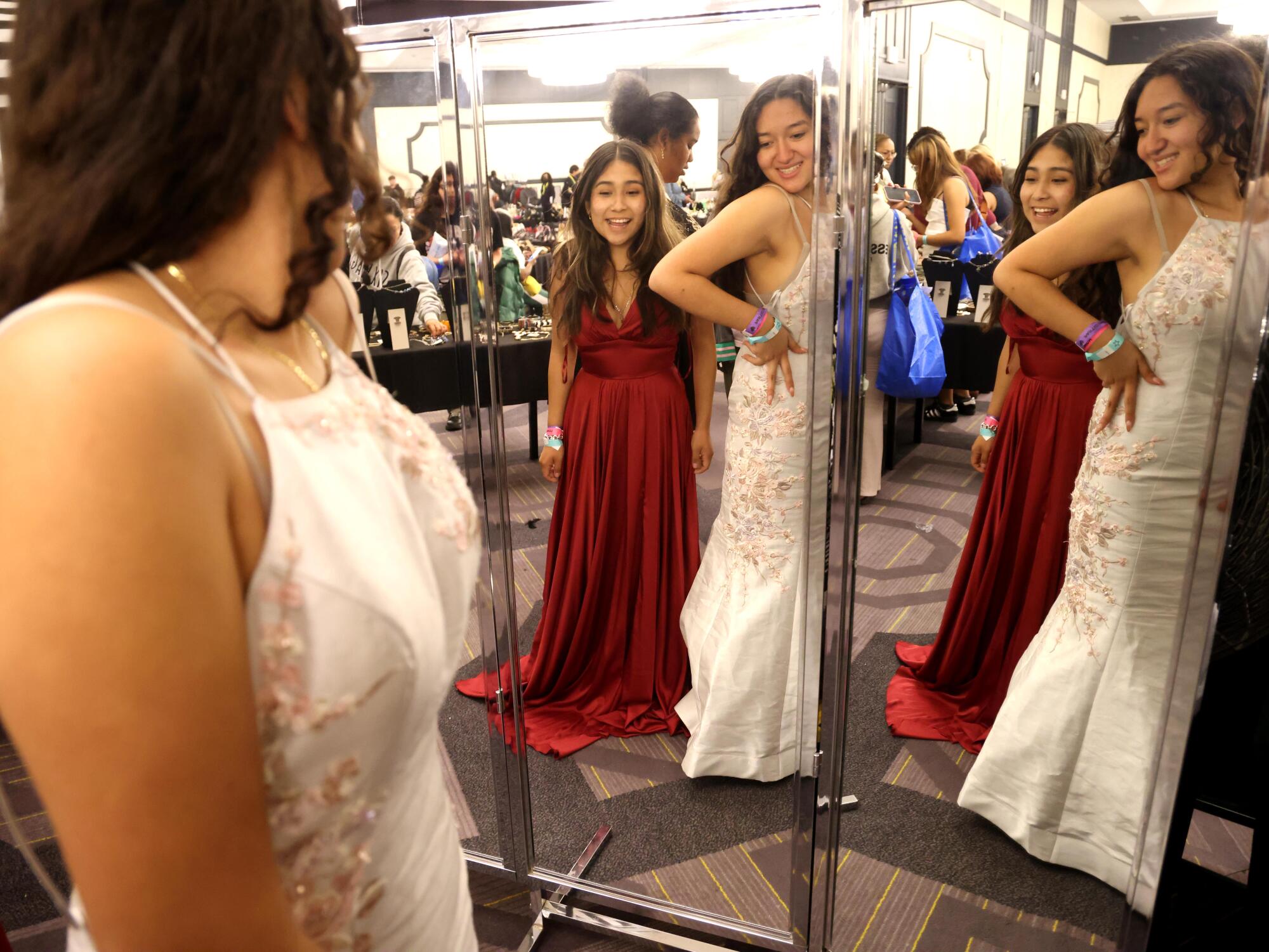 Chelsea Uribe and her friend Isabella Jimenez check themselves out while trying on prom dresses.