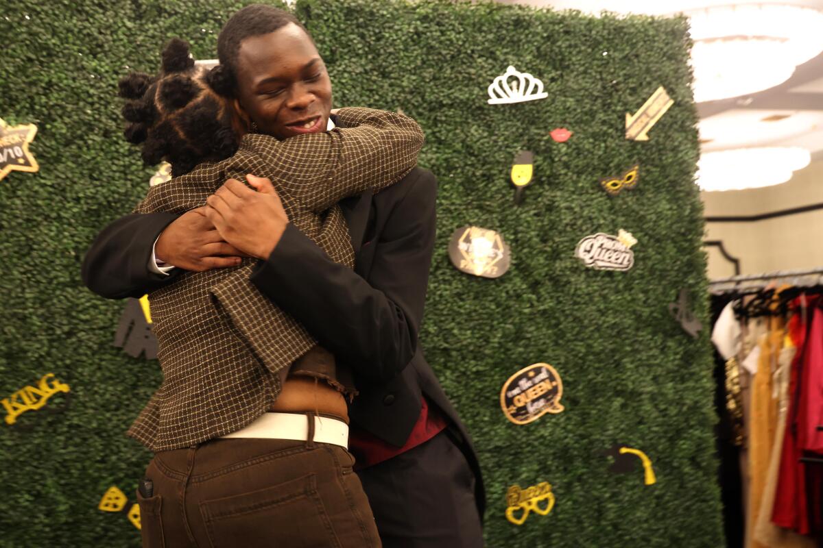 Jaidon Holmes receives a hug from volunteer Robin Johnson.