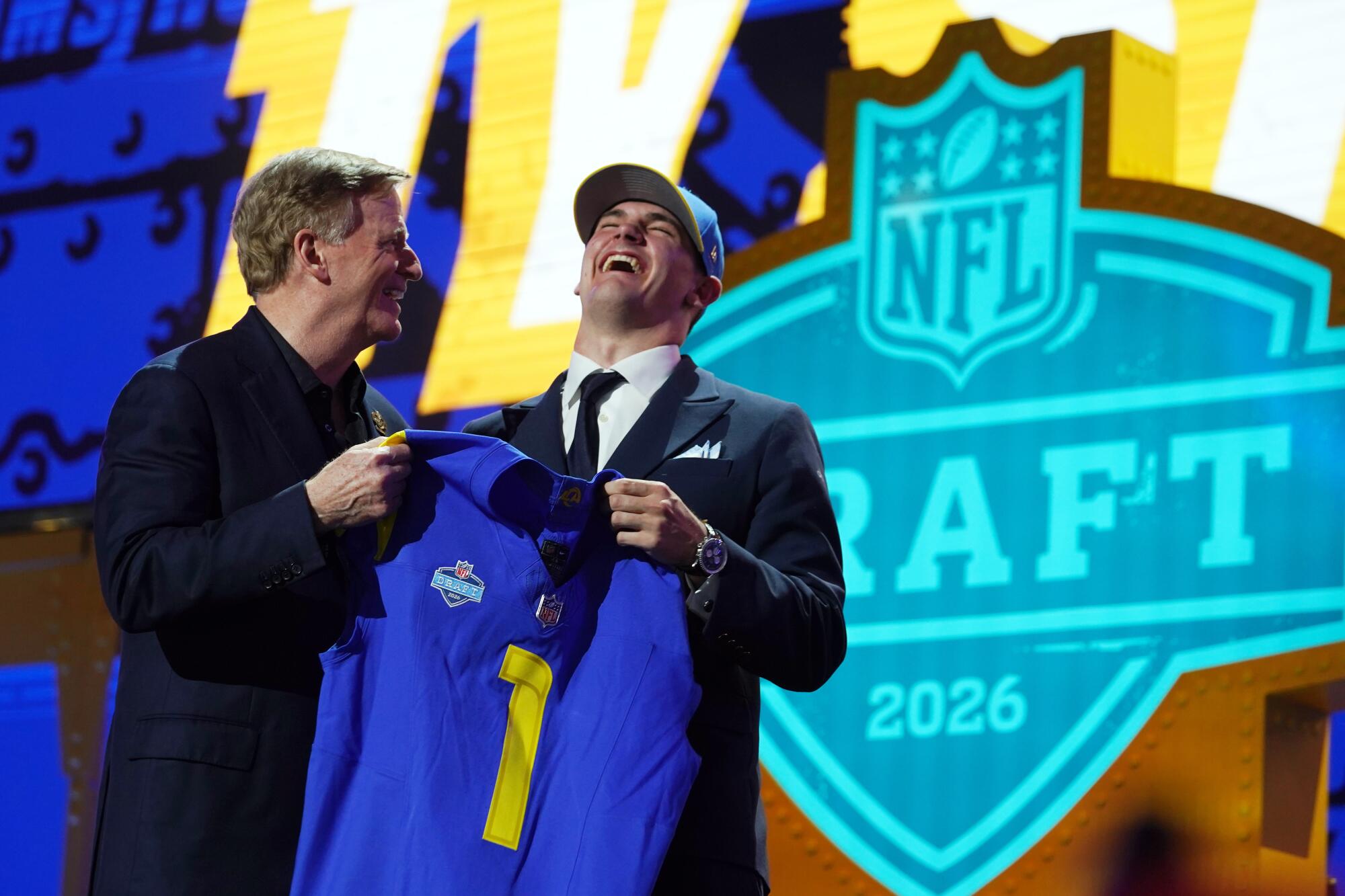 Alabama quarterback Ty Simpson laughs while standing on the draft stage with NFL Commissioner Roger Goodell on Thursday.