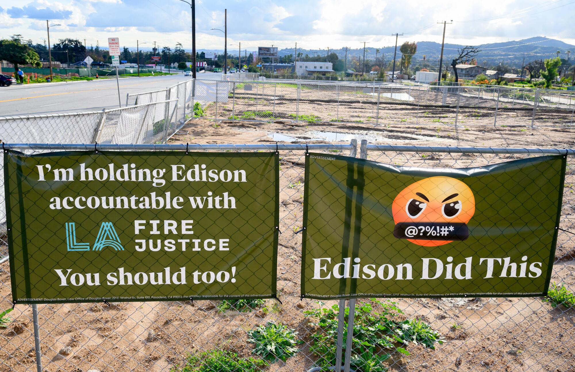Signs blaming Southern California Edison for the Eaton fire are seen near cleared lots.