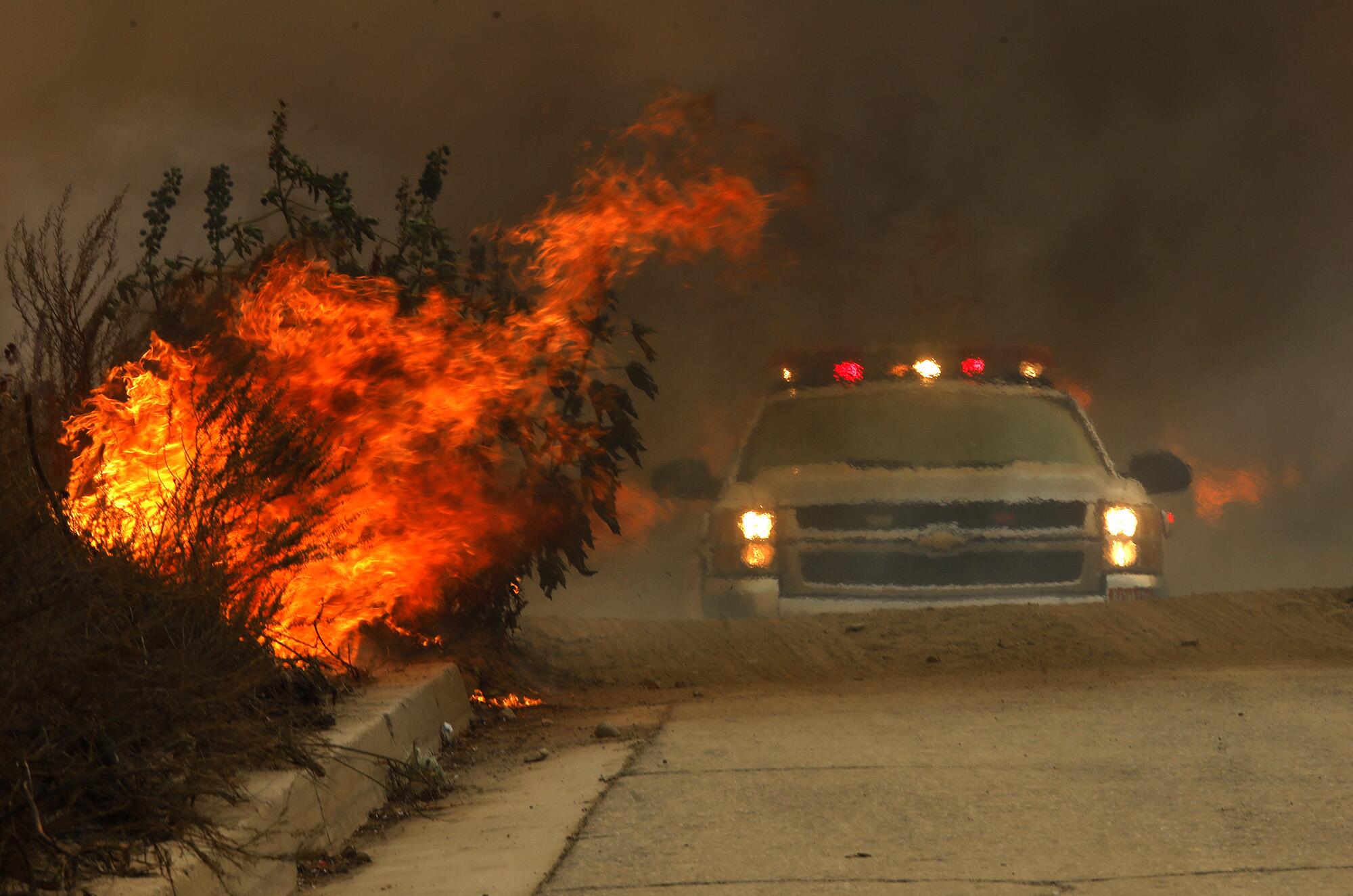 A fire truck makes its way past a portion of the Creek fire.