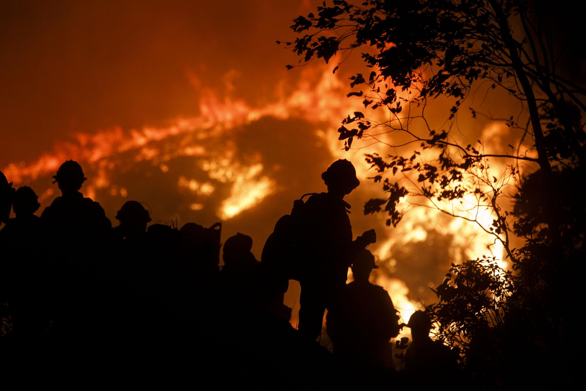 Firefighters work to contain a fire.