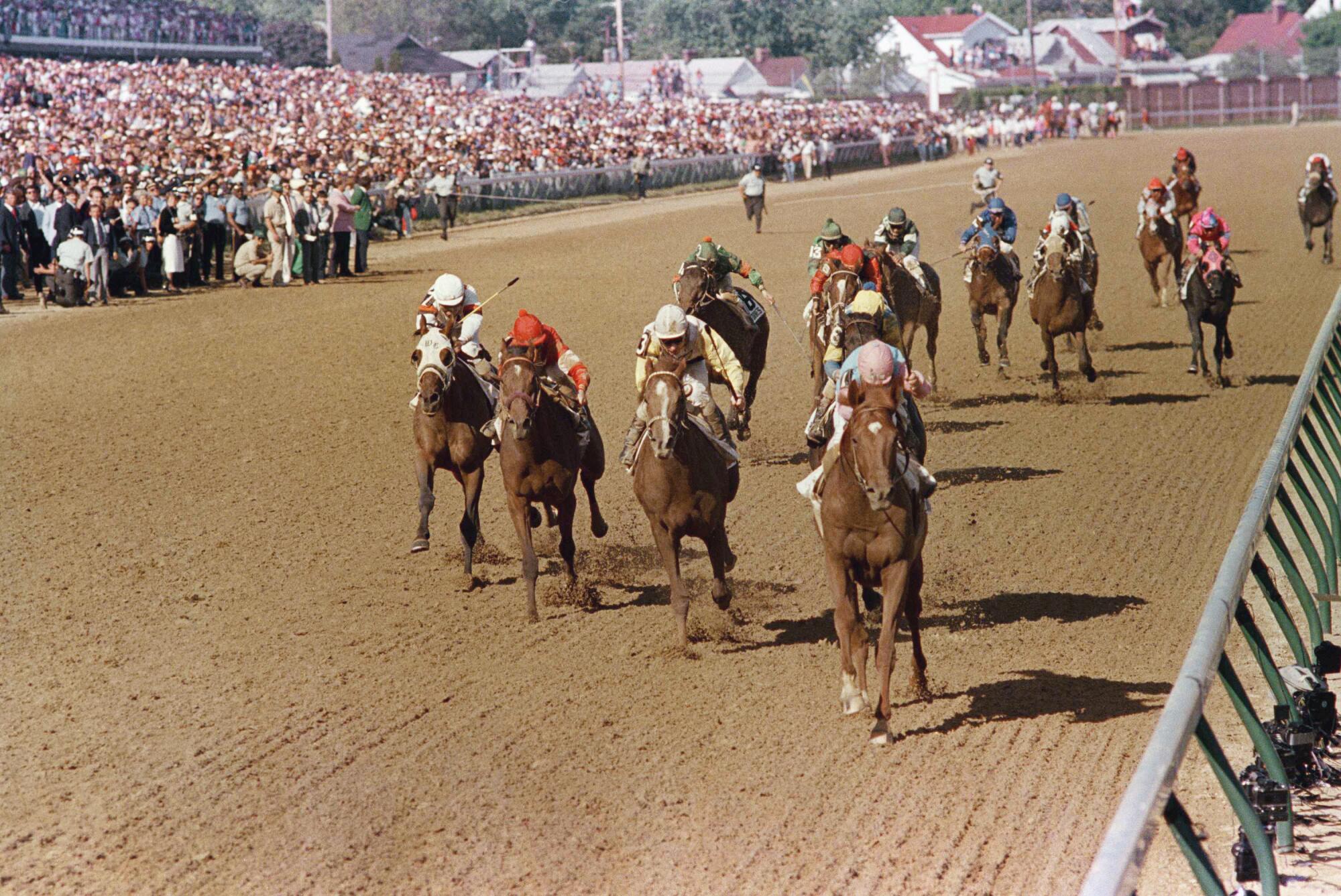 Ferdinand, ridden by Billy Shoemaker, heads down the homestretch to win the Kentucky Derby on May 5, 1986.
