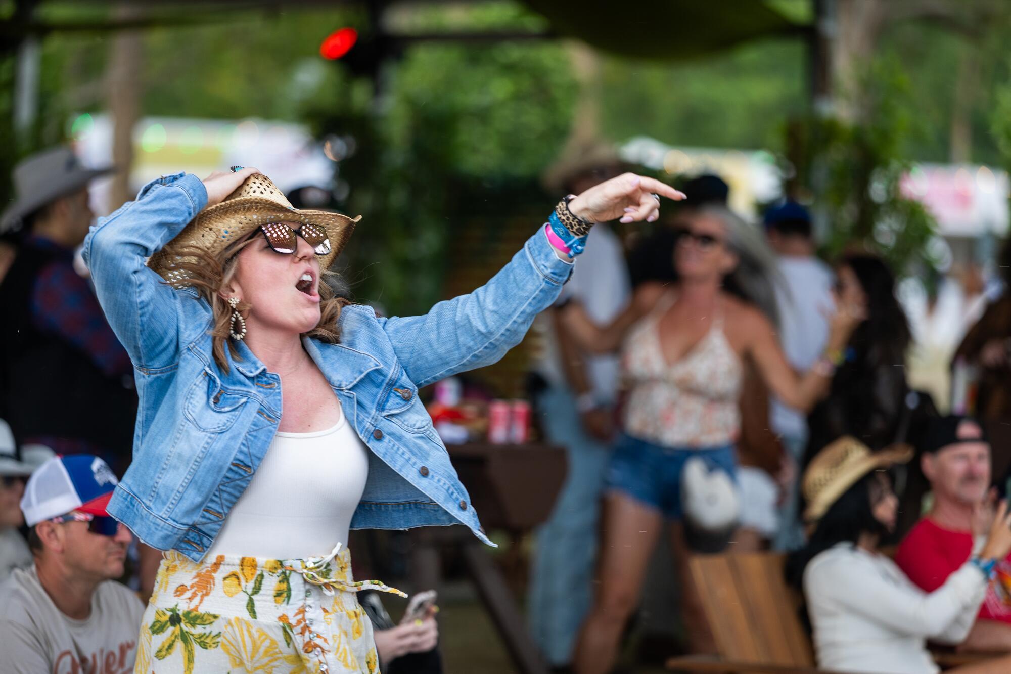 A woman holds onto her hat at Stagecoach