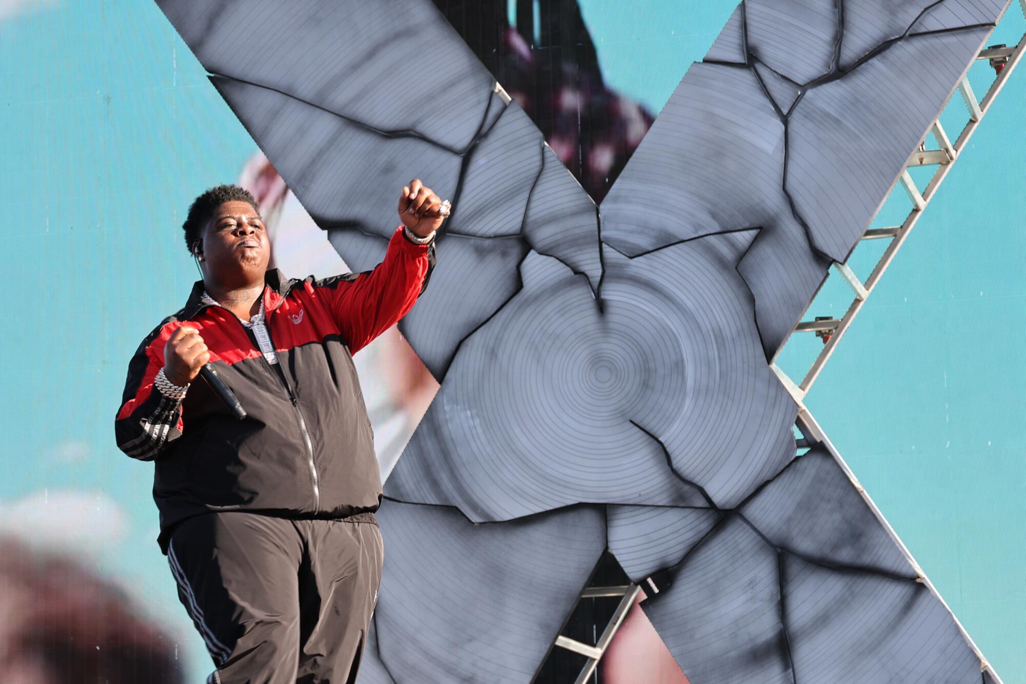 BigXThaPlug performs  in front of a big X at Stagecoach