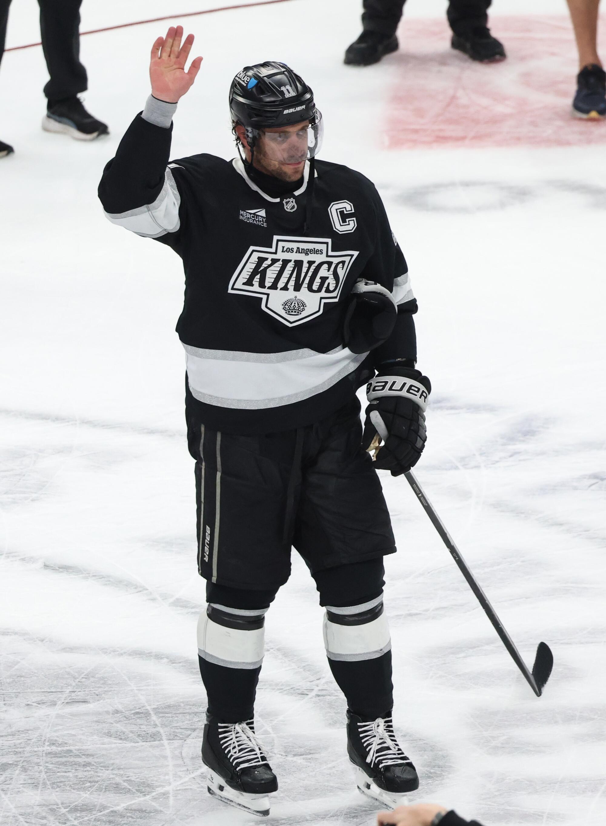 Kings captain Anze Kopitar acknowledges the crowd after playing in his final NHL game Sunday.