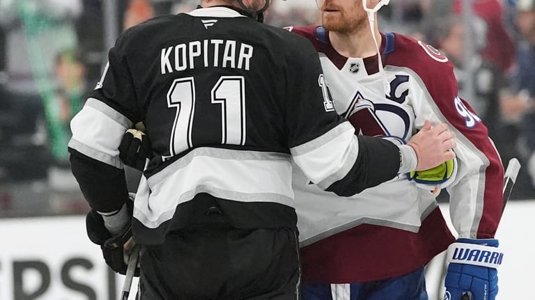 Colorado Avalanche's Gabriel Landeskog, right, greets Los Angeles Kings' Anze...