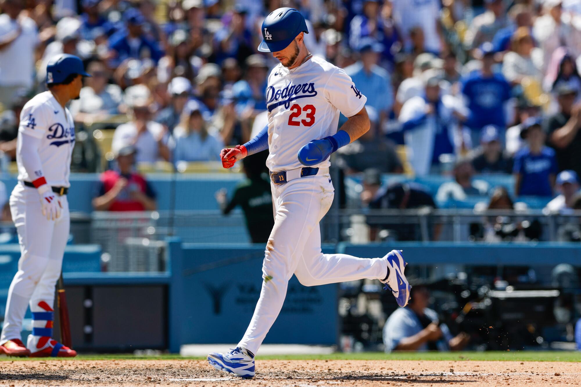 Kyle Tucker scores for the Dodgers in the fifth inning against the Chicago Cubs on Sunday.