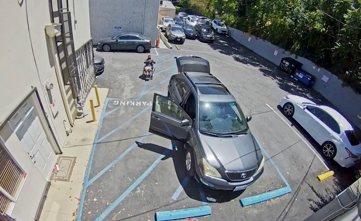 Anthony Bouyer takes a photo of parking lot at Toluca Pharmacy in Studio City. He later sued the pharmacy for ADA violations