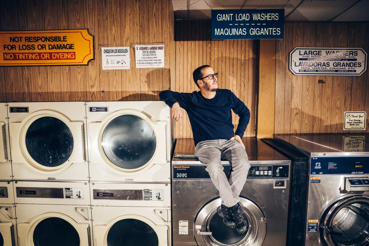 Kenny Majers atop one of his multi-load washers