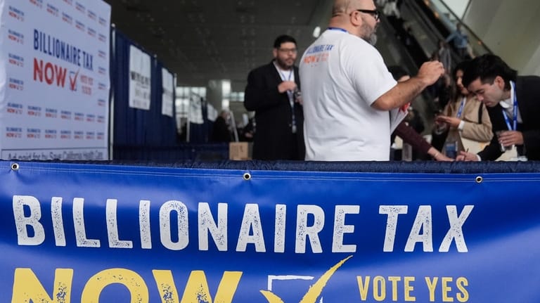 People visit the Billionaire Tax Now booth at the 2026...