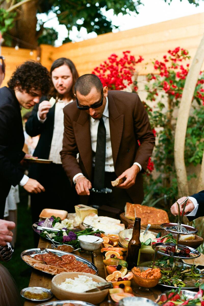 Wedding guests check out what's on offer at the grazing table.