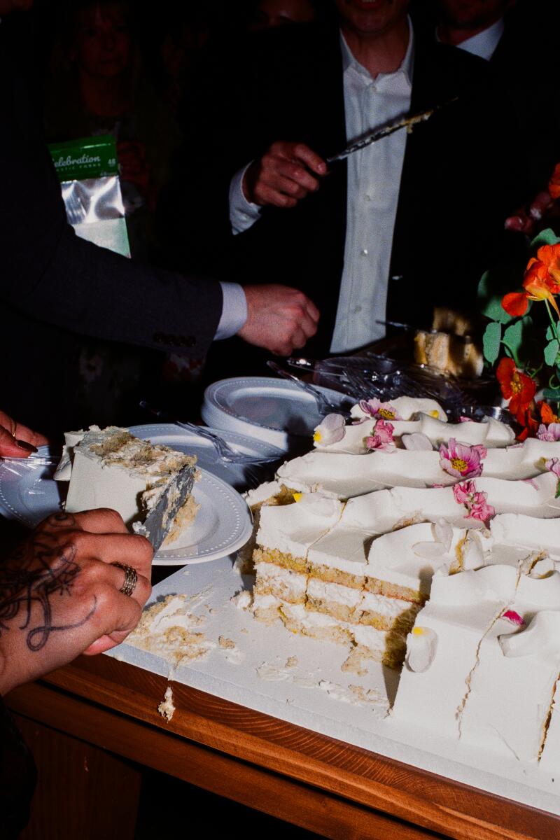 Wedding guests enjoy the grazing table and cake.