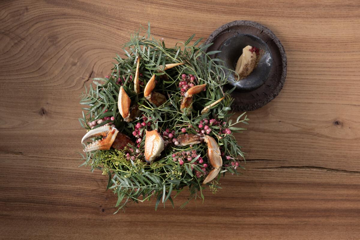 Dungeness crab garnished with pink peppercorns.
