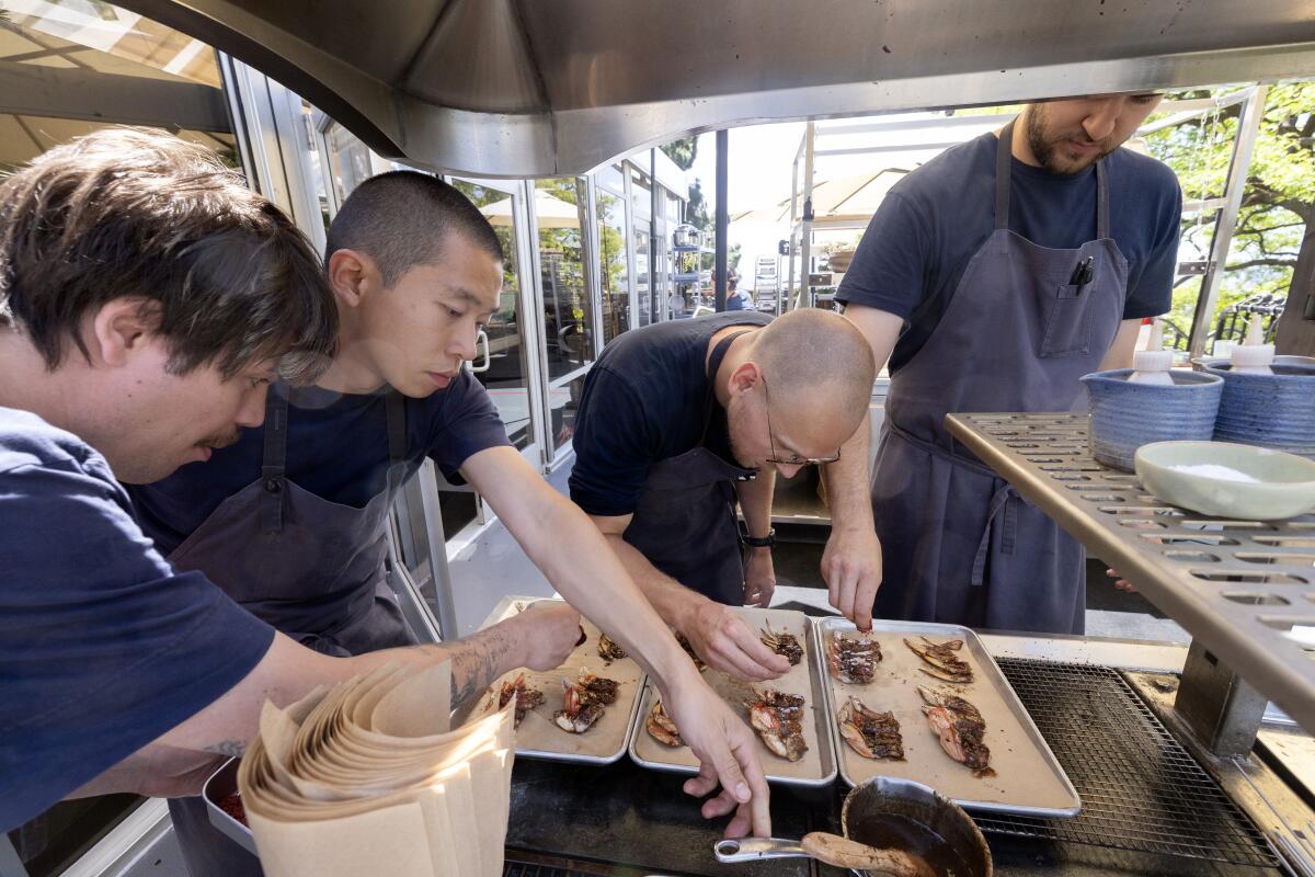 Noma LA chefs prep and grill Dungeness crab.