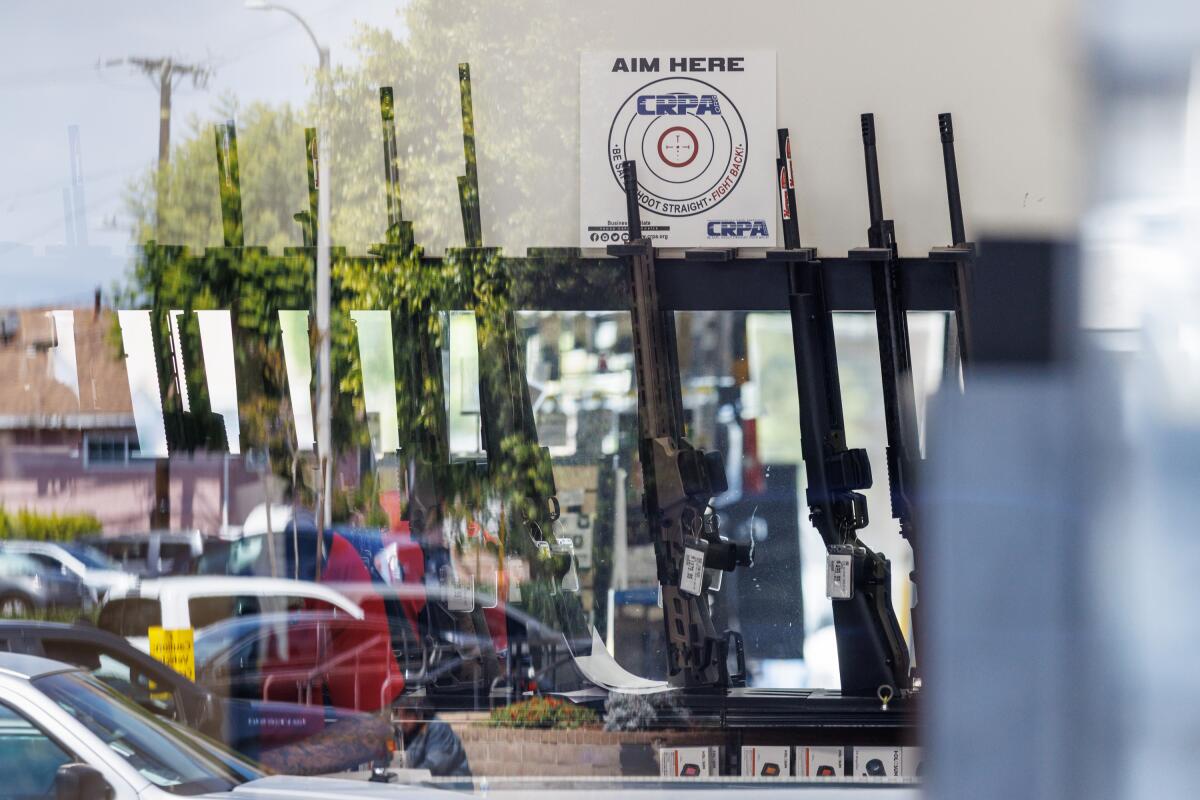 Rifles line the back sales section of Turner's Outdoorsman 