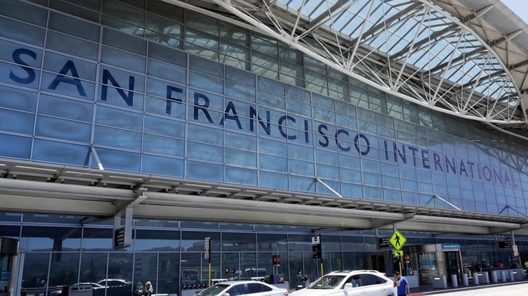 Vehicles wait outside the international terminal at San Francisco International...