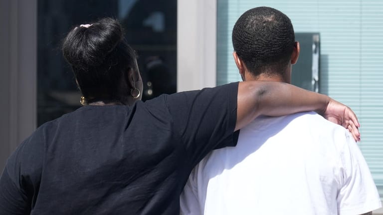 Oakland Ceasefire-Lifeline life coach LaSasha Long, left, puts her arm...