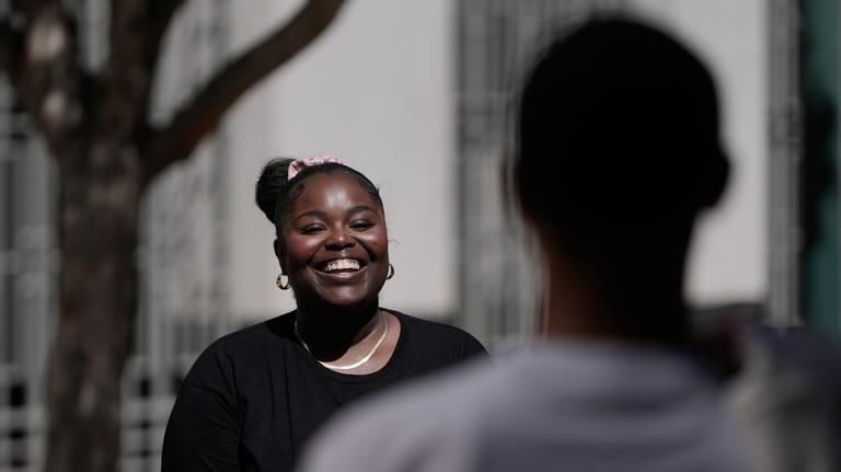 Oakland Ceasefire-Lifeline life coach LaSasha Long, left, laughs with Bernard...