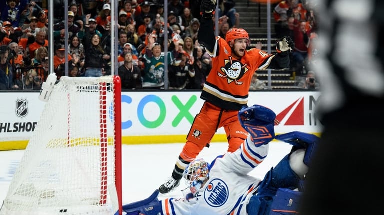 Anaheim Ducks center Tim Washe, top, reacts on goal by...