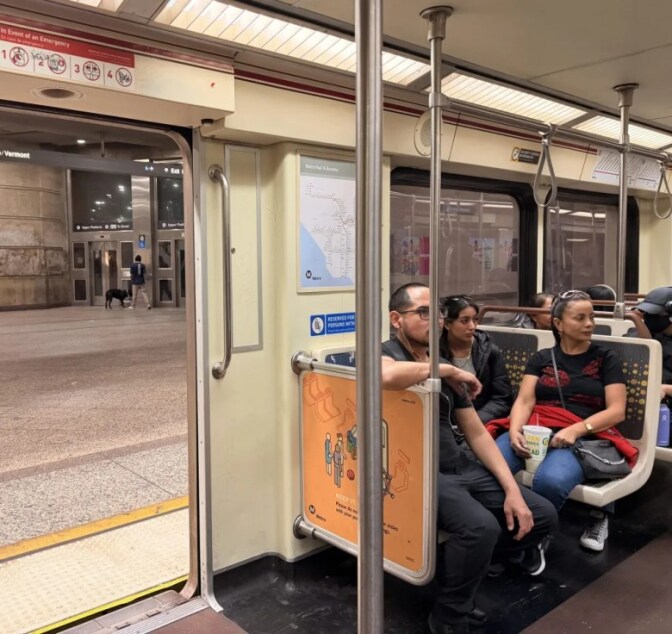 People wait inside the train.