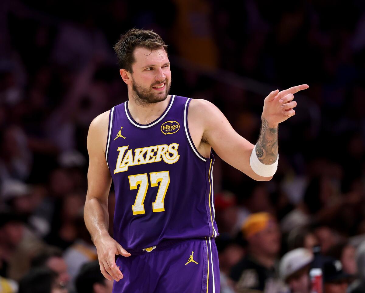 Lakers guard Luka Doncic winks while pointing across the court after scoring.