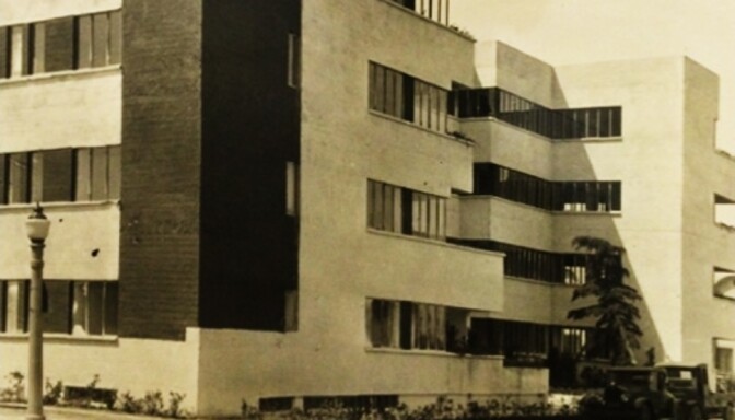 A black and white photo shows an apartment building constructed in 1928 in Hollywood, California.
