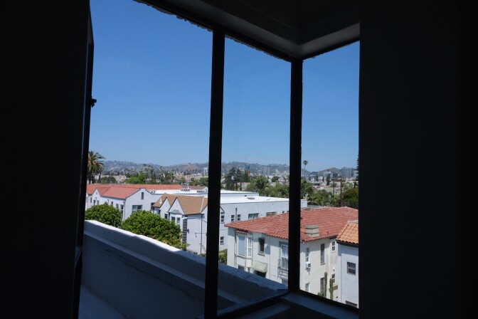 Windows join at a right angle along two walls of an apartment building in Hollywood.