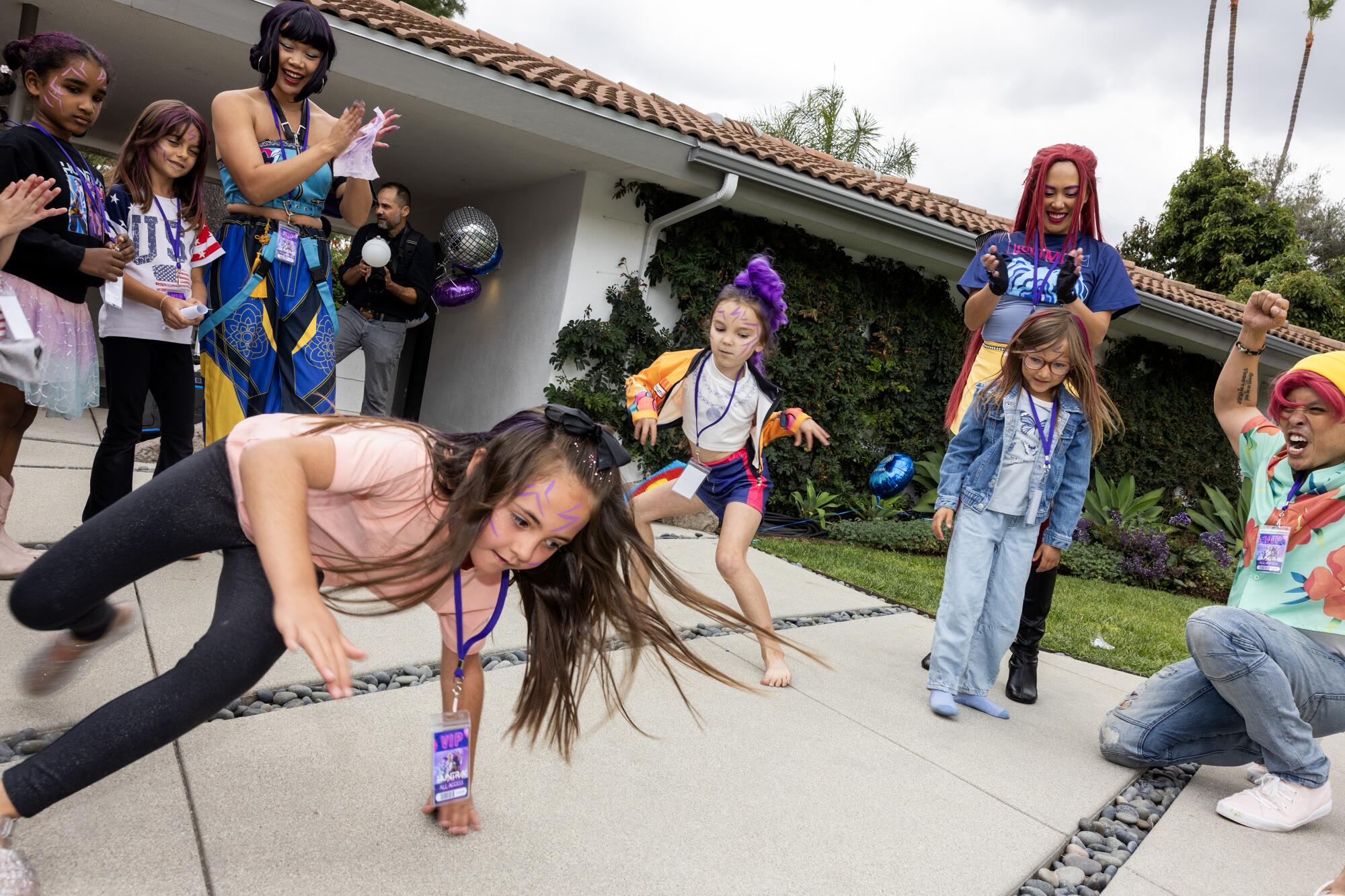 Madelynn Wheater, 7, left, and Parker Apel, 7, center, show off their best moves in the dance circle.
