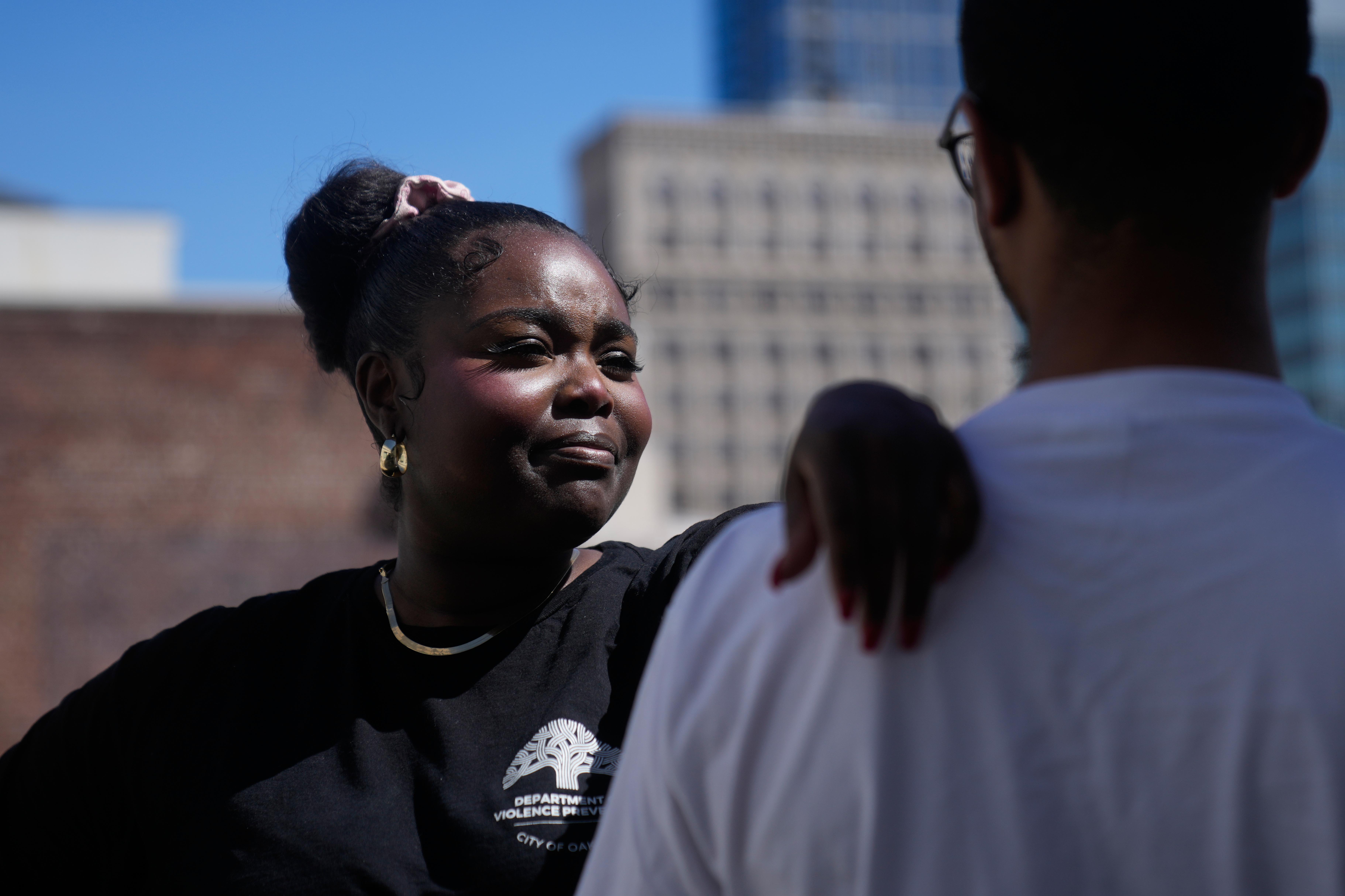 Oakland Ceasefire-Lifeline life coach LaSasha Long, left, poses for photos...