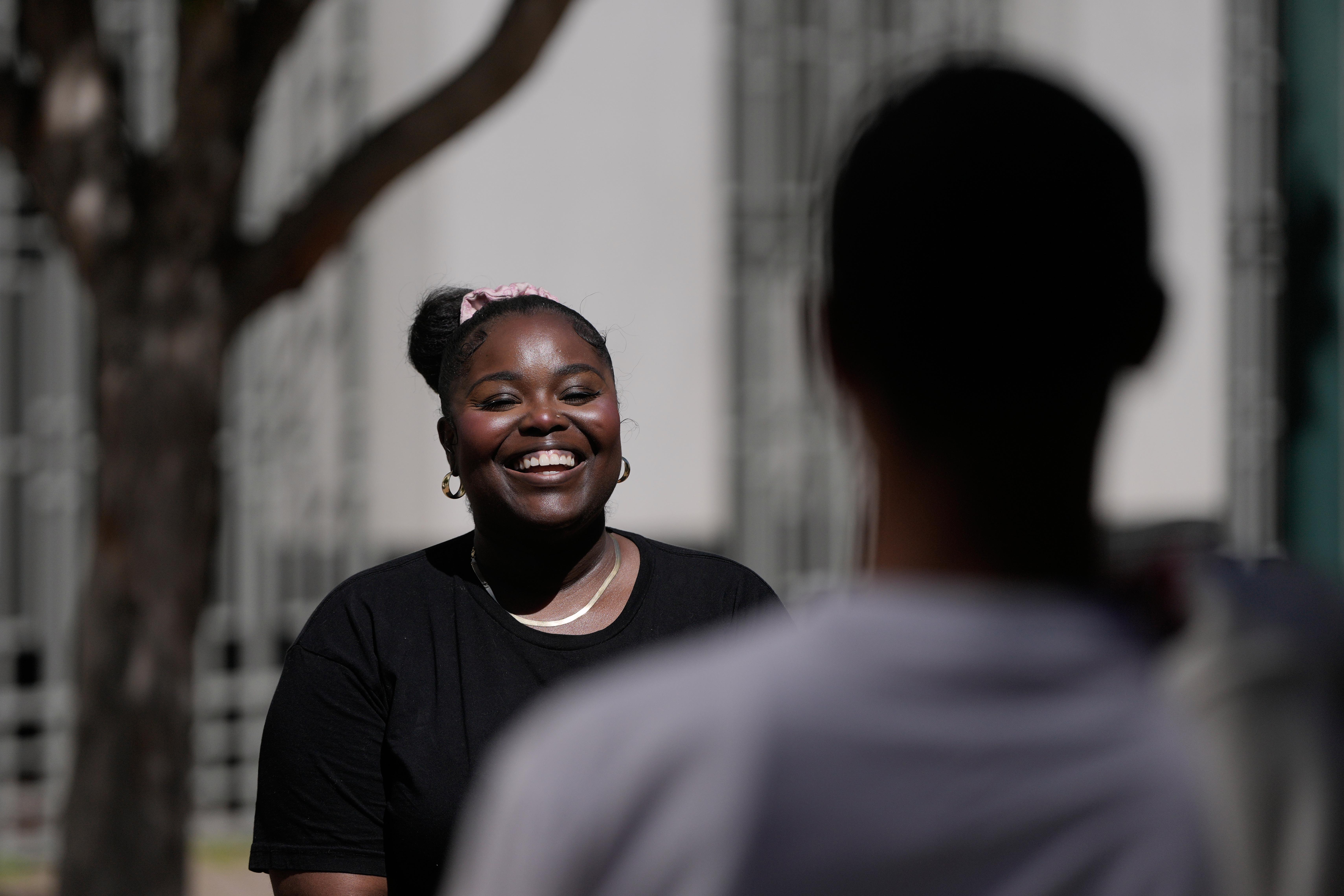 Oakland Ceasefire-Lifeline life coach LaSasha Long, left, laughs with Bernard...