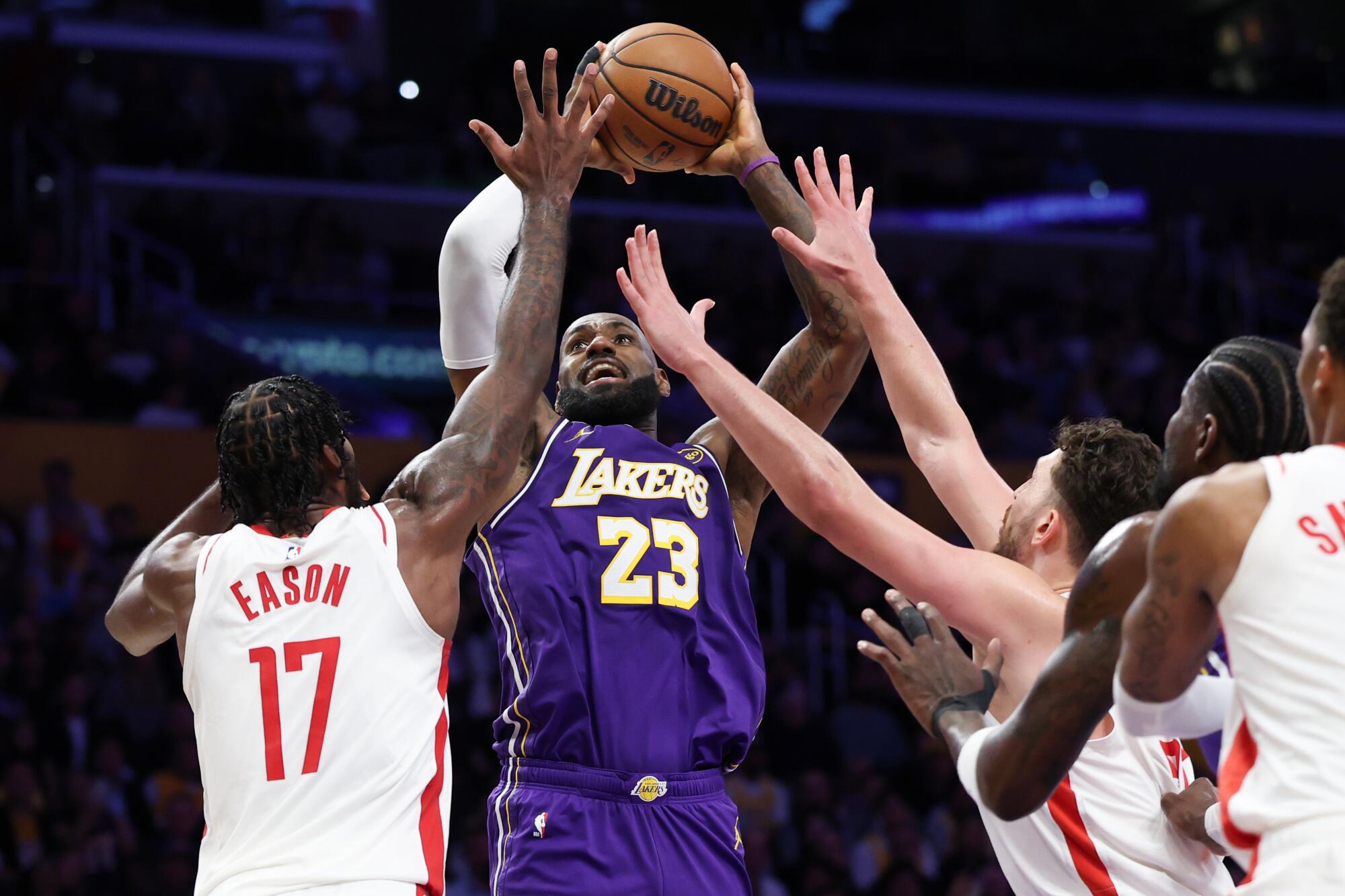 Lakers forward LeBron James goes up for a shot under pressure from Rockets forward Tari Eason and center Alperen Sengun.